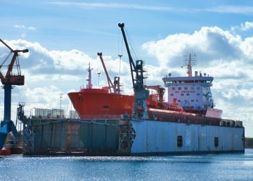 Ship being constructed in a shipyard. Photo by Rasmus Andersen on Unsplash.